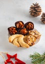 Assorted Christmas cookies and sweets on a round plate on a light concrete background in Christmas style. Merry Christmas concept