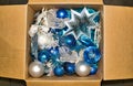 Assorted Christmas ornament decorations stored in an open cardboard box. Royalty Free Stock Photo