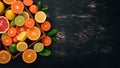 Assorted citrus fruit in a wooden box. Orange, tangerine, grapefruit, lemon. On a wooden background. Royalty Free Stock Photo