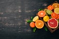 Assorted citrus fruit in a wooden box. Orange, tangerine, grapefruit, lemon. On a wooden background. Royalty Free Stock Photo