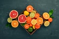 Assorted citrus fruit in a wooden box. Orange, tangerine, grapefruit, lemon. On a wooden background. Royalty Free Stock Photo