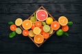 Assorted citrus fruit in a wooden box. Orange, tangerine, grapefruit, lemon. On a wooden background. Royalty Free Stock Photo