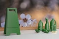 Assorted cleaning products all in green on a floral background of almond trees. 3d rendering.