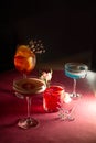 assorted cocktails on a pink background in the dark