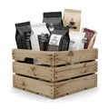 Assorted coffee beans in a wooden crate with various packaging Royalty Free Stock Photo
