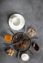 Assorted coffee, tea, cocoa, sugar, honey and a white porcelain cup