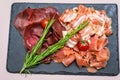 Assorted cold cuts with herbs on a plate. horizontal frame Royalty Free Stock Photo