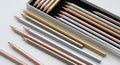 Assorted colored pencils arranged neatly in a box on a white surface Royalty Free Stock Photo