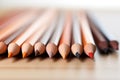 Assorted colored pencils in a row, closeup, School supplies.