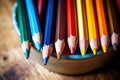 Assorted colored pencils in a row, closeup, School supplies.