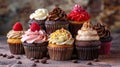 Assorted colorful cupcakes with various toppings arranged on wooden surface Royalty Free Stock Photo