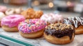 Assorted colorful donuts with sprinkles and glaze in a bakery. Royalty Free Stock Photo