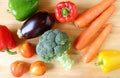 Assorted colorful fresh vegetables scattered on wooden background Royalty Free Stock Photo