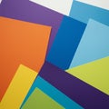 Assorted colorful paper sheets overlap each other, creating an abstract pattern. The Royalty Free Stock Photo