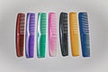 Assorted colorful plastic hair straightener combs on plain white Royalty Free Stock Photo