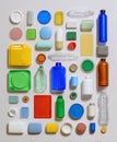 Assorted colorful plastic waste arranged on a clean, neutral background, highlighting environmental concerns Royalty Free Stock Photo