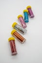 Assorted colors craft glitter in small tubes with yellow caps is
