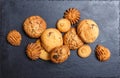 Assorted cookies with chocolate chip, oatmeal raisin on stone slate background on wooden background close up. Homemade baking