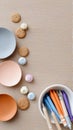 Assorted cookies and colorful crayons on beige background with bowls Royalty Free Stock Photo