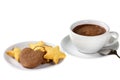 Assorted cookies on white dessert plate and cup of hot chocolate