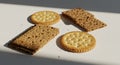 Assorted crackers on white surface with natural light and shadows, close up shot Royalty Free Stock Photo