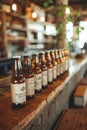 Assorted craft beer bottles lined up on a wooden counter at a local brewery, each label featuring unique artwork and branding
