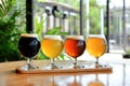 Assorted craft beer flight on wooden paddle in modern brewery setting Royalty Free Stock Photo