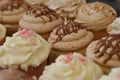 Assorted Cupcakes with frosting and decorations on display at bakery Royalty Free Stock Photo