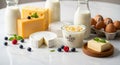 Assorted dairy products and eggs are arranged on a marble surface. There are blocks of yellow Royalty Free Stock Photo