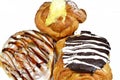 Assorted Danish pastry with brown dark chocolate, white chocolate, caramel sauce and pastry cream, sweet bakery dough baked in the