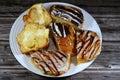 Assorted Danish pastry with brown dark chocolate, white chocolate, caramel sauce and pastry cream, sweet bakery dough baked in the