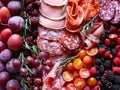 Assorted Delicatessen Meats with Fresh Berries, Grapes, and Tomatoes Arrangement Close Up