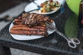 Assorted delicious grilled meat with salad in background white plate on table for family bbq party