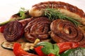 Assorted delicious grilled meat with vegetable on a barbecue with grilled sausages and vegetables on table Royalty Free Stock Photo