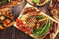 Assorted delicious grilled meat with vegetable on rustic table Royalty Free Stock Photo