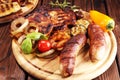 Assorted delicious grilled meat with vegetable on rustic table Royalty Free Stock Photo