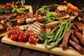 Assorted delicious grilled meat with vegetable on rustic table Royalty Free Stock Photo