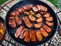 Assorted delicious grilled meat with vegetable over the coals on a barbecue.