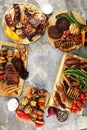 Assorted delicious grilled meat with vegetable on rustic table Royalty Free Stock Photo