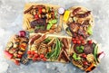 Assorted delicious grilled meat with vegetable on rustic table Royalty Free Stock Photo