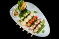 Assorted delicious mixed grilled with vegetable on white plate on black background Royalty Free Stock Photo
