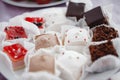 Assorted desserts on white plate, strawberry and chocolate cakes