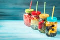 Assorted detox water cocktails in glass jars on wooden background Royalty Free Stock Photo