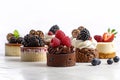 Assorted different mini cakes with cream, chocolate and berries Royalty Free Stock Photo