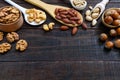 Assorted different nuts, prunes, pumpkin seeds in spoons Royalty Free Stock Photo