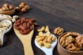 Assorted different nuts, prunes, pumpkin seeds in spoons Royalty Free Stock Photo