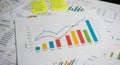 Assorted documents with printed charts, graphs, and tables spread across a surface. Royalty Free Stock Photo