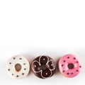 Assorted donuts with chocolate frosted and pink glazed isolated on white background, top view Royalty Free Stock Photo