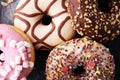 Assorted donuts with chocolate frosted, pink glazed and sprinkle