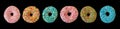 Doughnuts with colorful decoration isolated on black color background. Top view